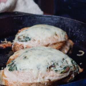 Chicken topped with cheese and spinach.