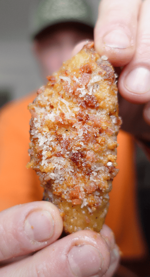 A wing with bacon and parmesan cheese.