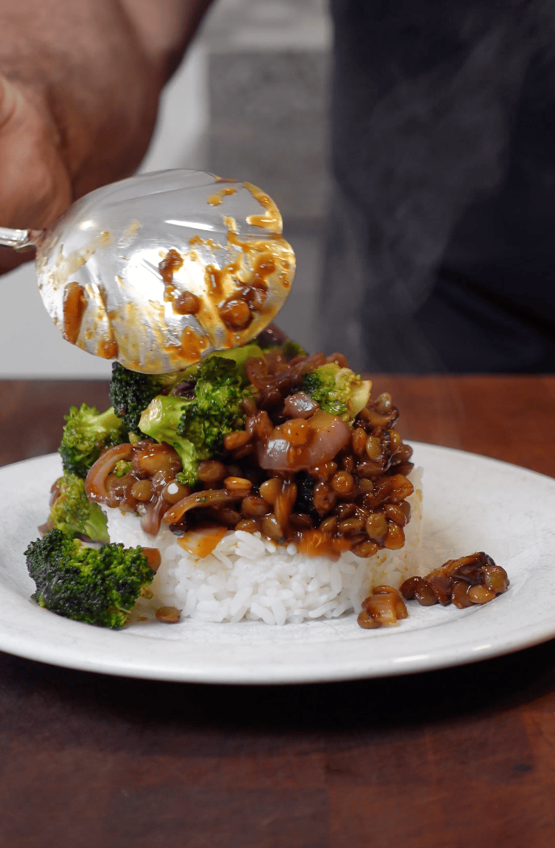 Plating Asian Broccoli Stir Fry on a bed of rice