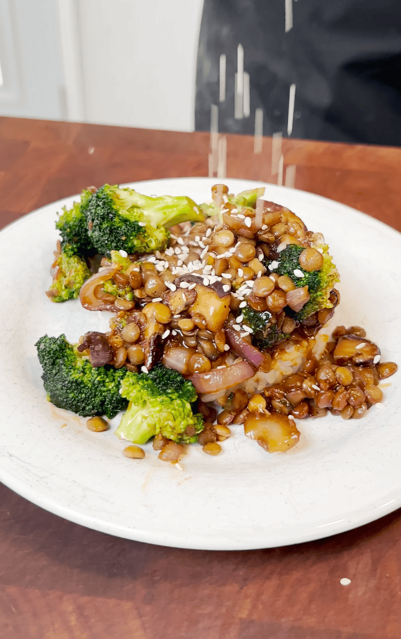 garnishing Plating Asian Broccoli Stir Fry with sesame seeds