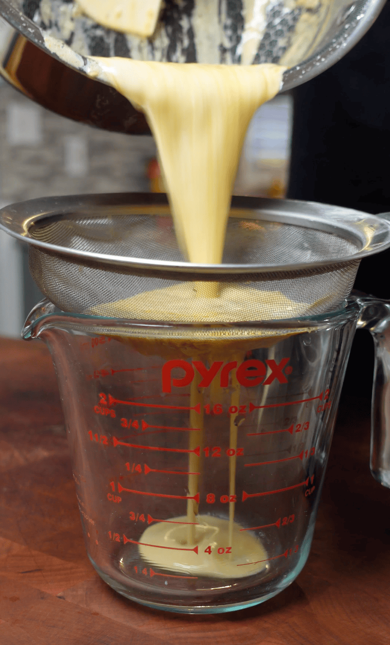 Sauce straining into measuring cup.