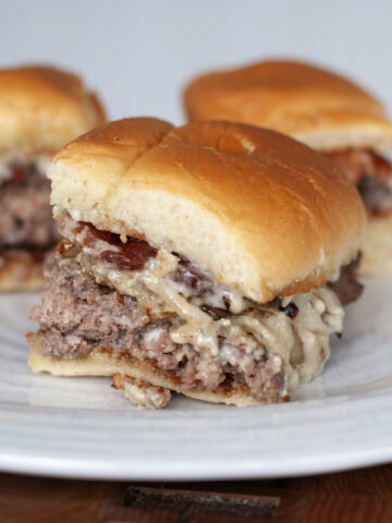A beef slider with cheese and sautéed onions.