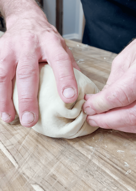 Folding pastry around the Wellington.