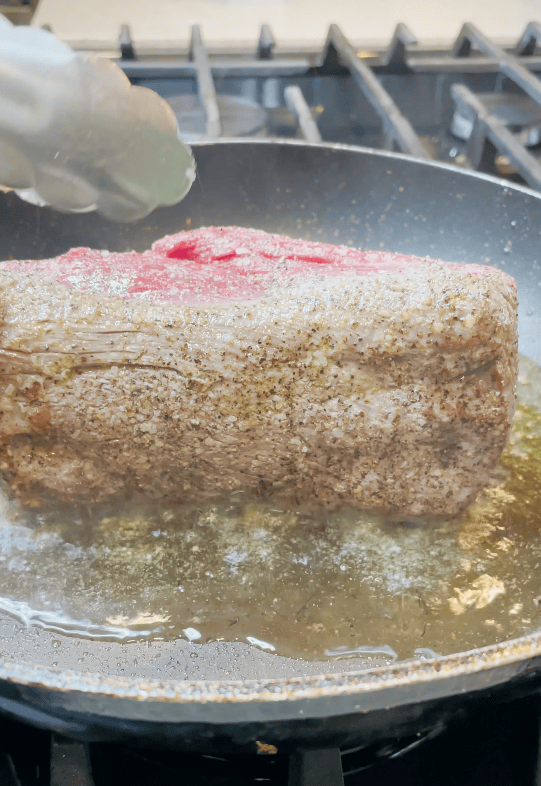 Beef searing on a skillet.