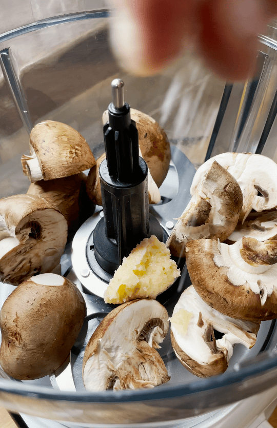 Mushrooms and garlic in a blender.