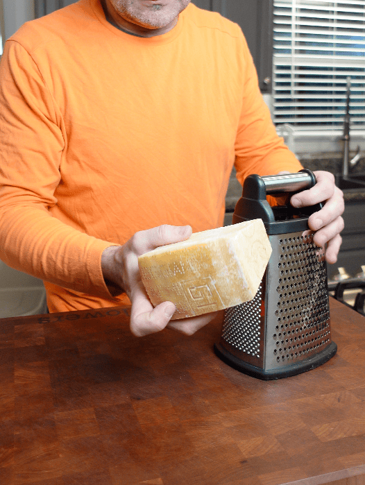 Shredding parmesan cheese.