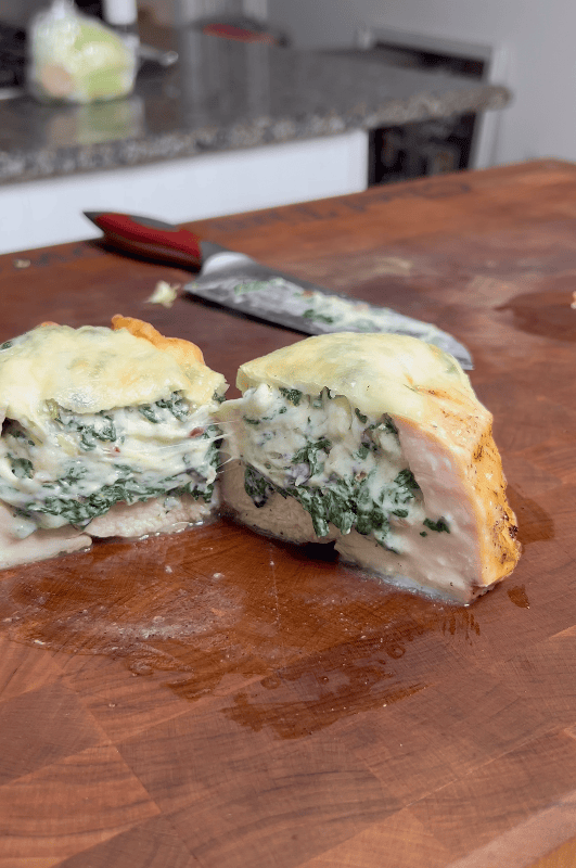 Chicken with creamed spinach cut in half.
