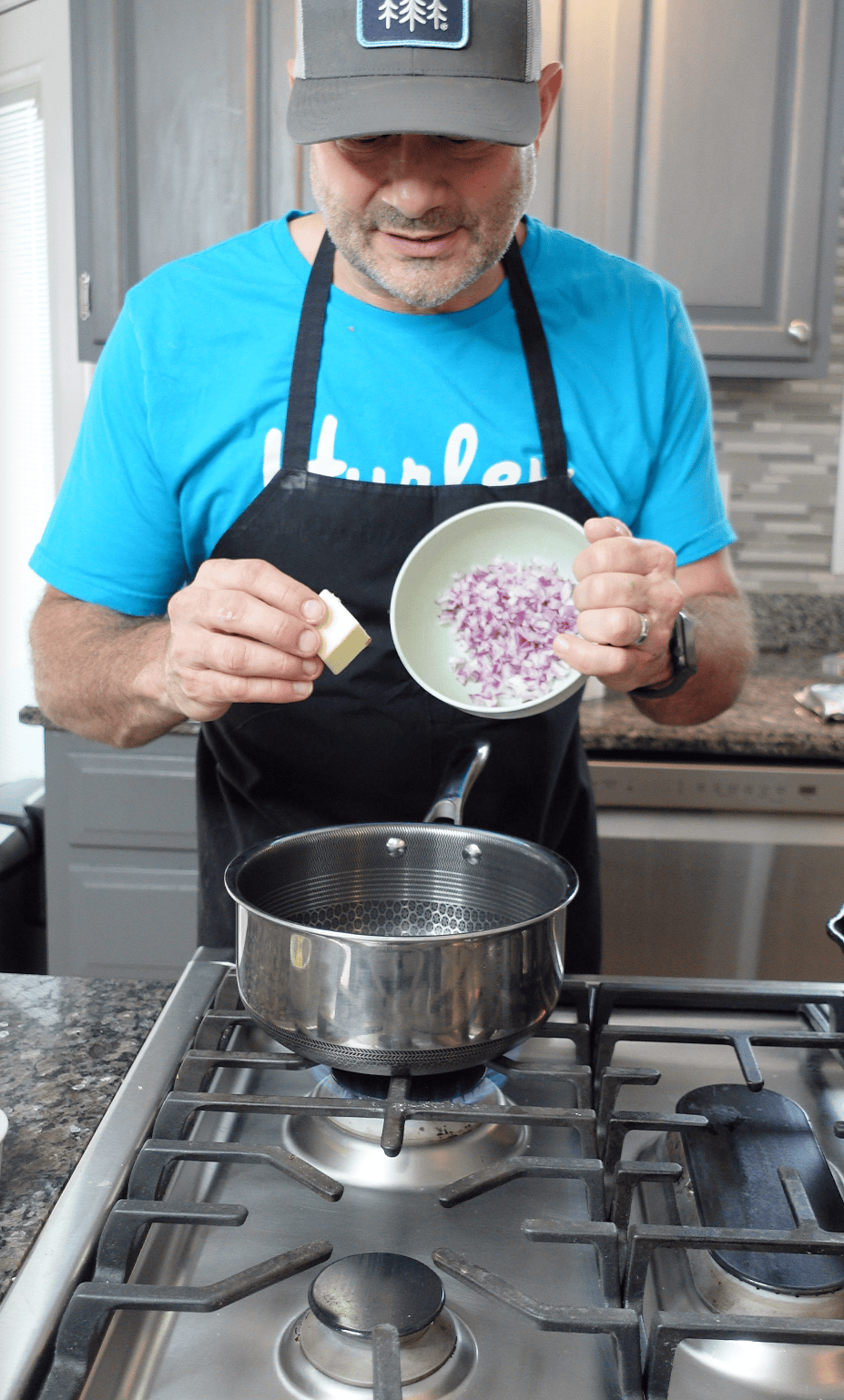 Onion and butter going into a pot.