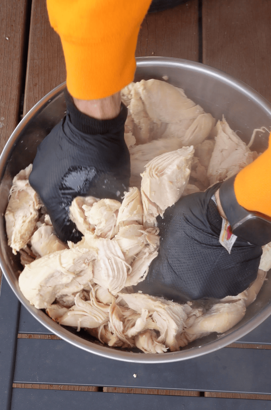 Shredding boiled chicken.