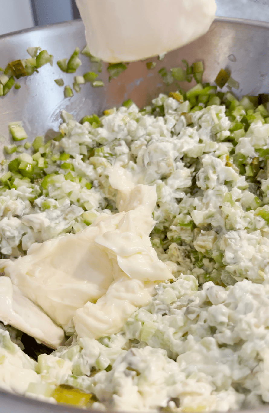 Mayo going into mixture.