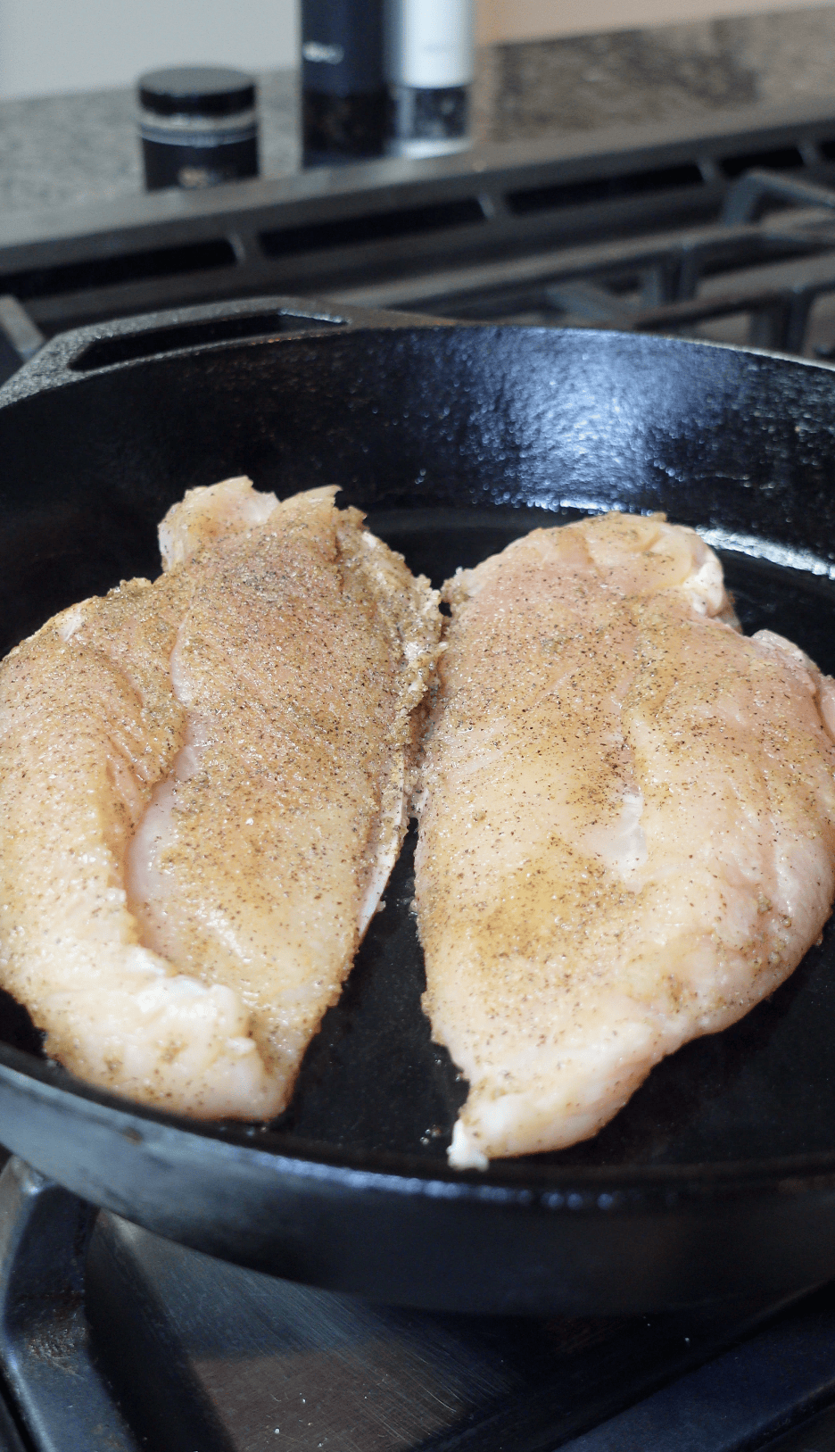 Chicken cooking in a skillet.
