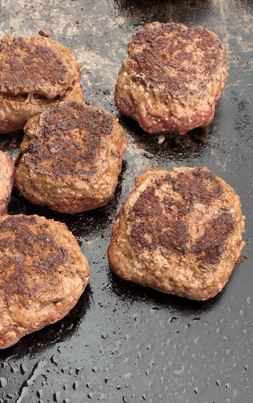 Hamburger patties on the griddle.