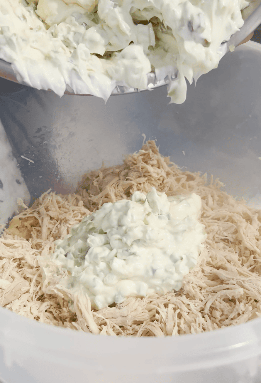 Mayo mixing into chicken.