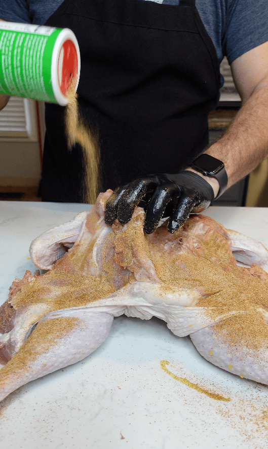 A turkey being seasoning.