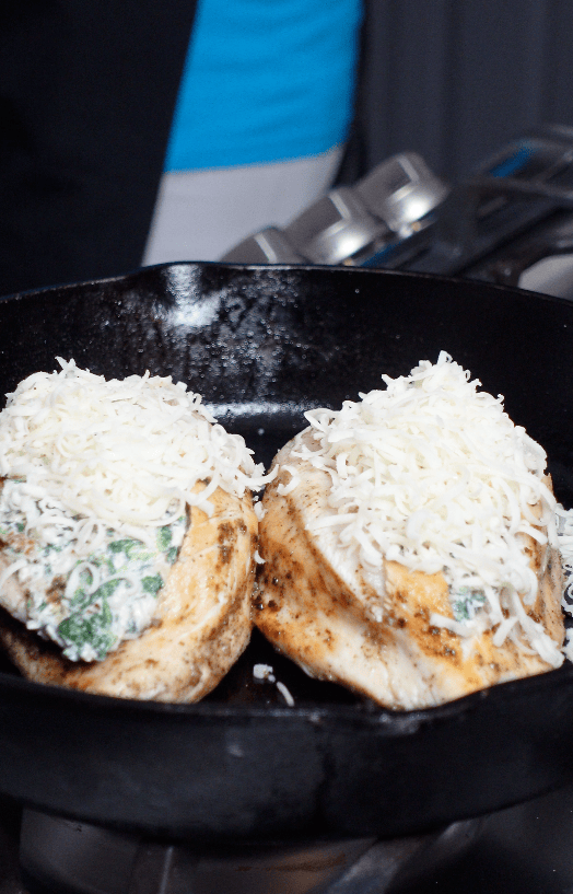 Cheese on top of chicken breasts.