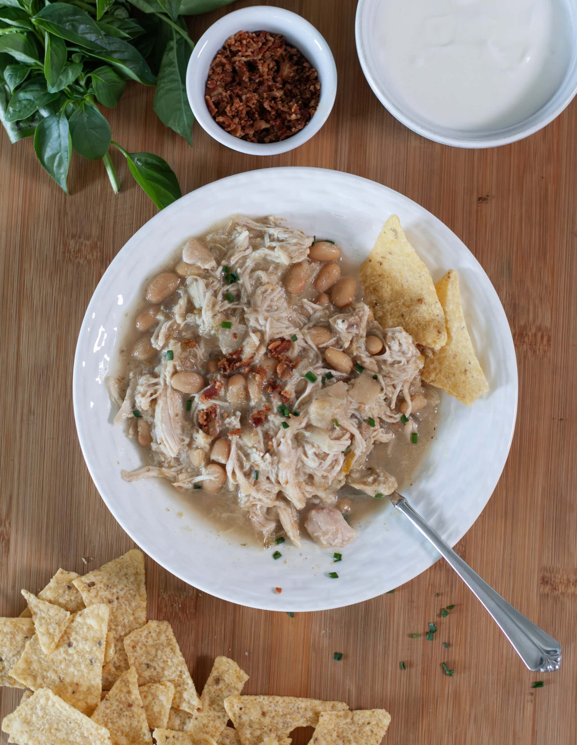 Chicken chili with chives and bacon bits.