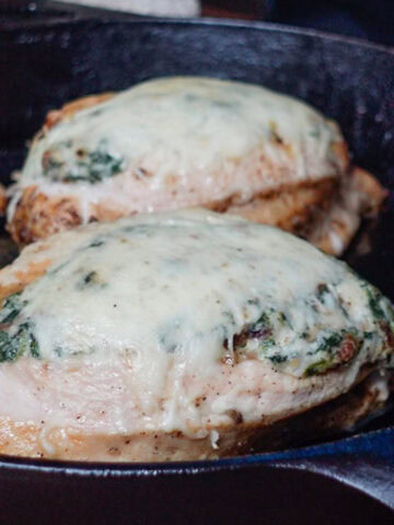 two chicken breast filled with creamed spinach.