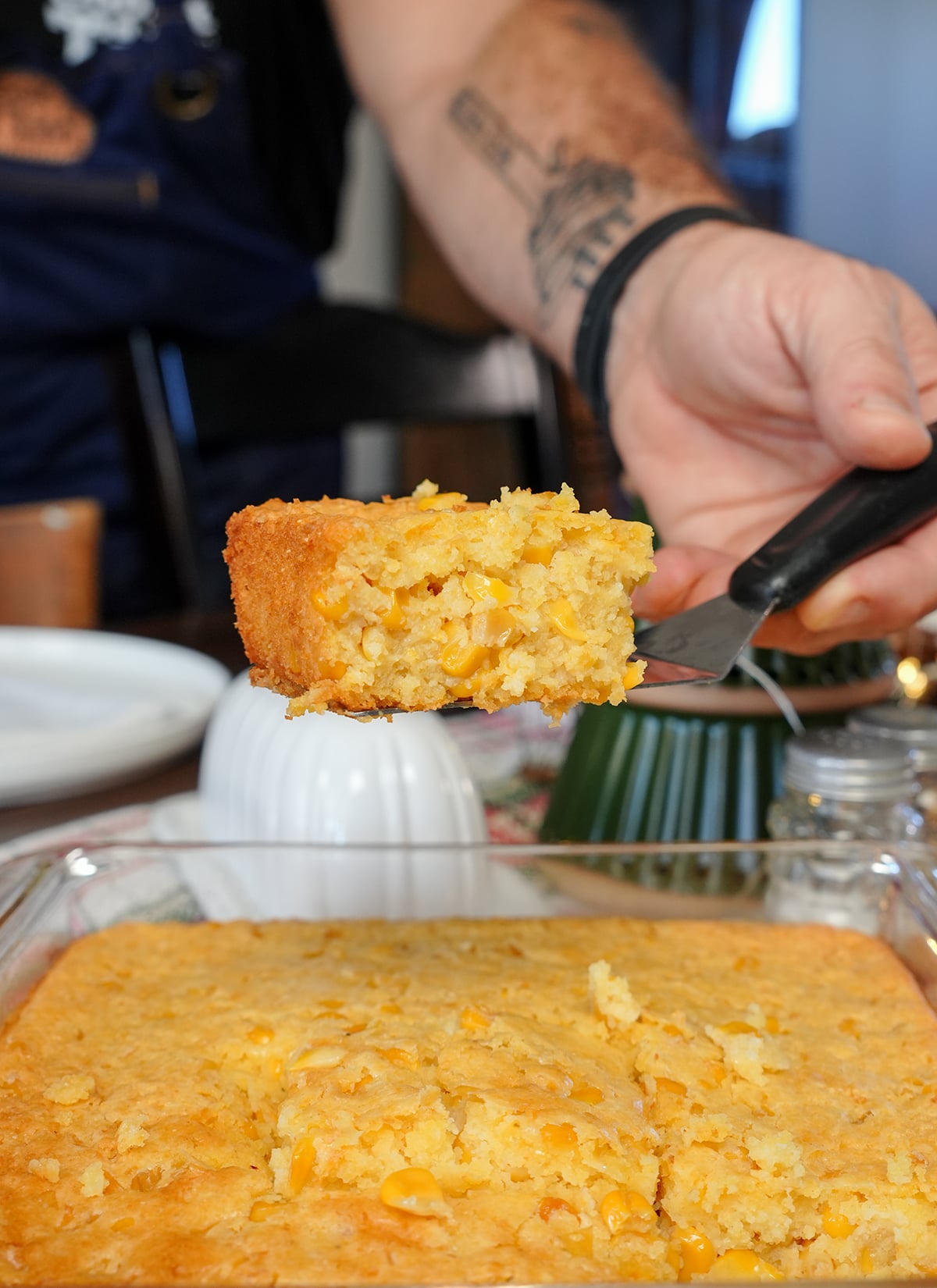 a scoop of corn casserole on a spatula.