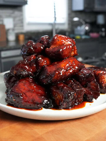 Burnt ends with bbq sauce on a plate.