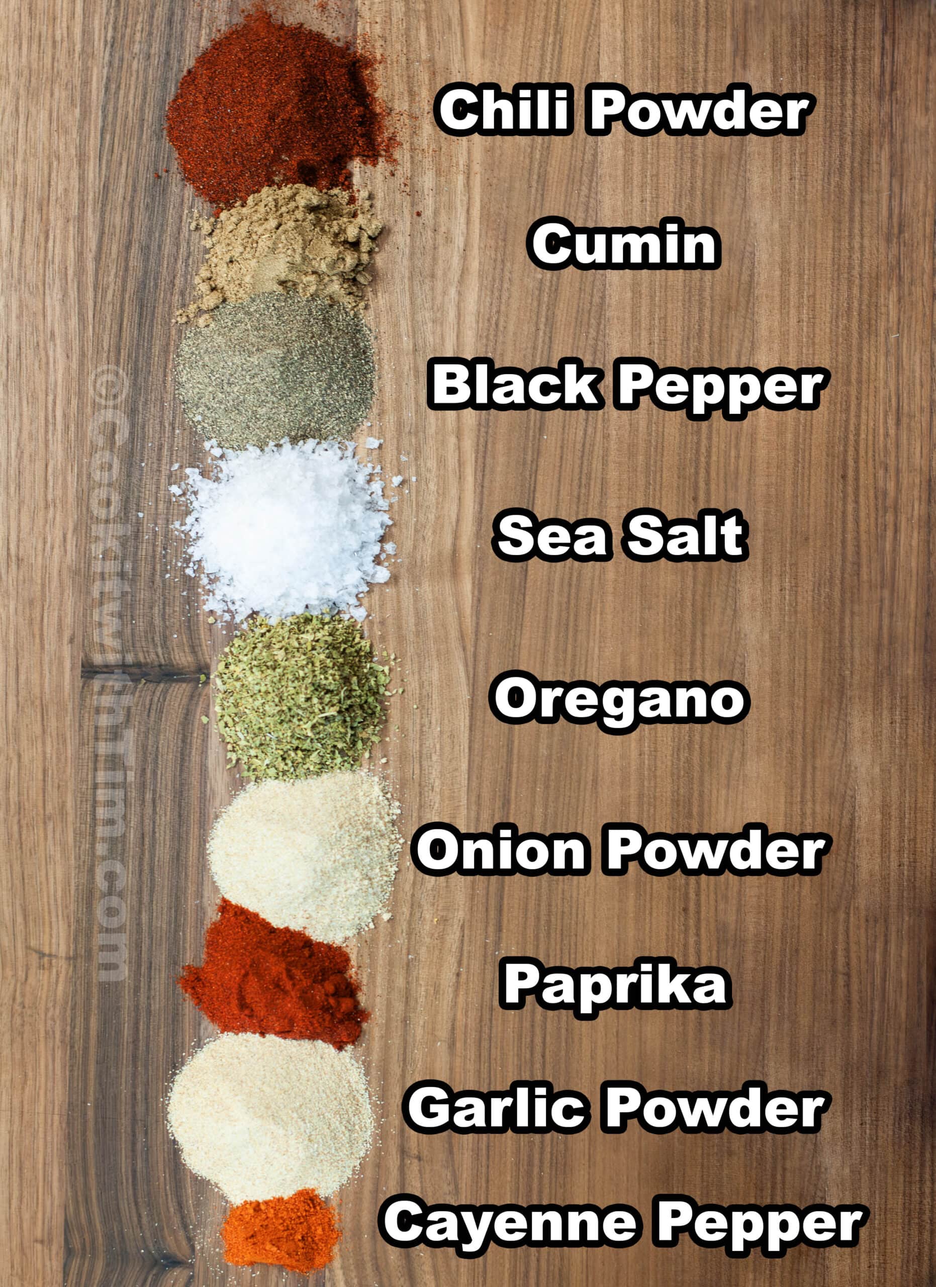 Seasonings laid out on a board.
