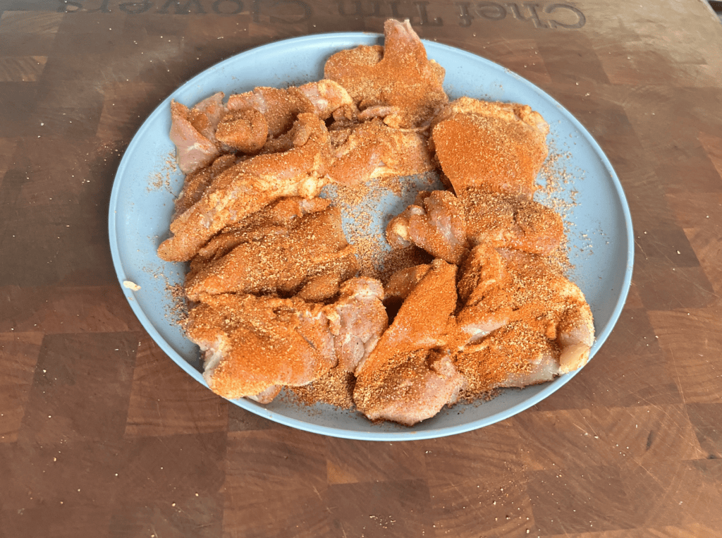 A plate of seasoned chicken thighs.
