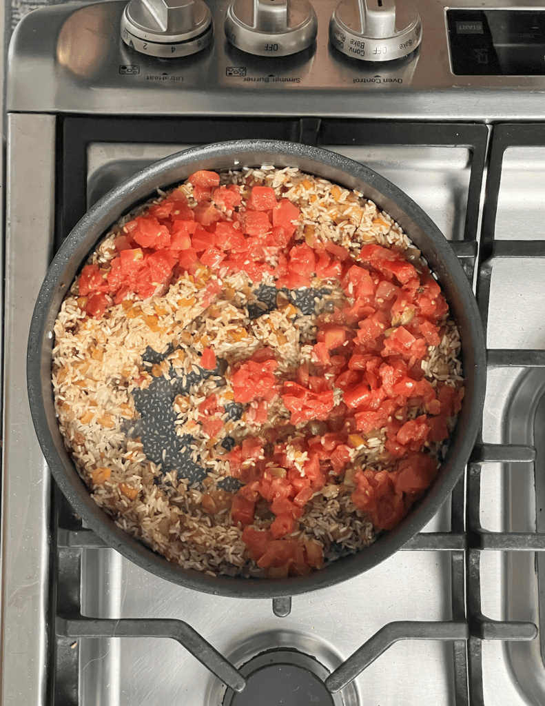 Rice and tomatoes in a stock pot.