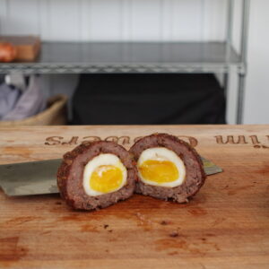 A scotch egg cut in half.