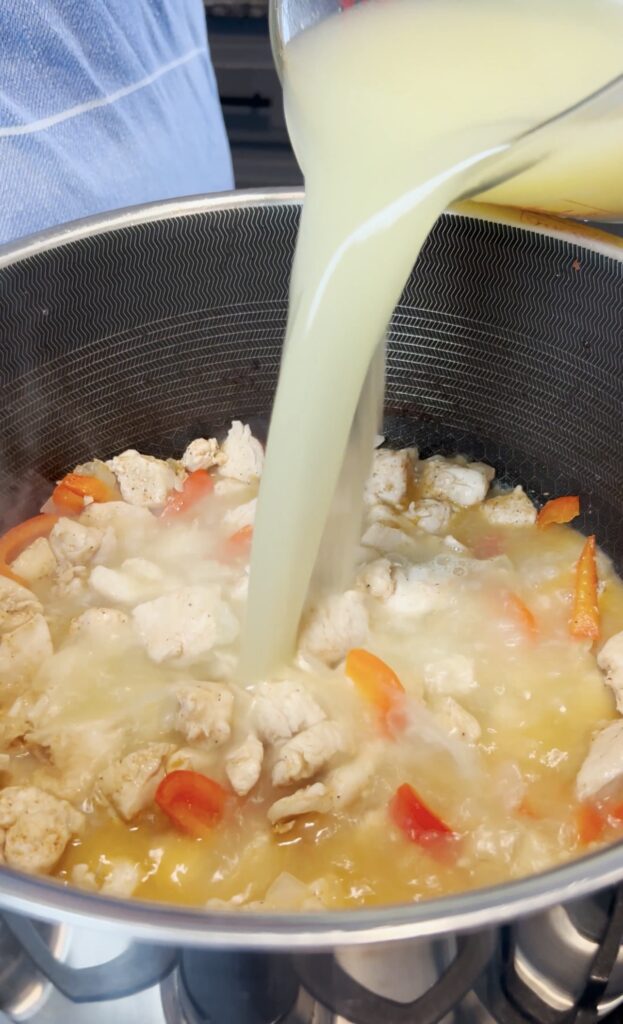 Chicken broth going into a pot.