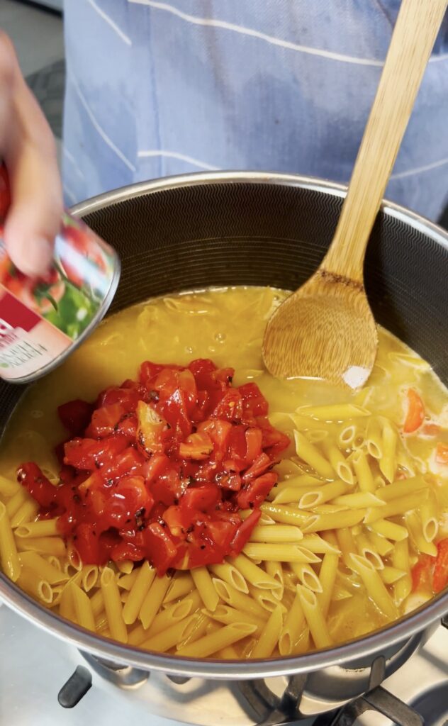 Tomatoes going into pasta.