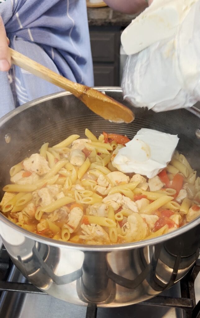 Cream cheese going into a pot.