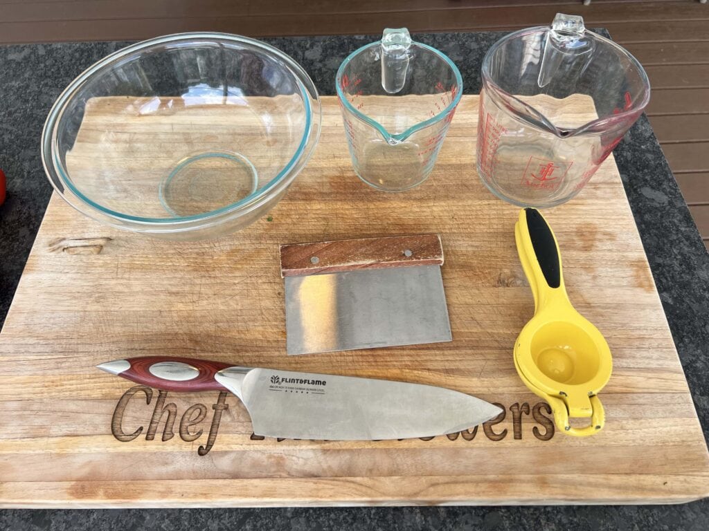 Kitchen tools on a cutting board.