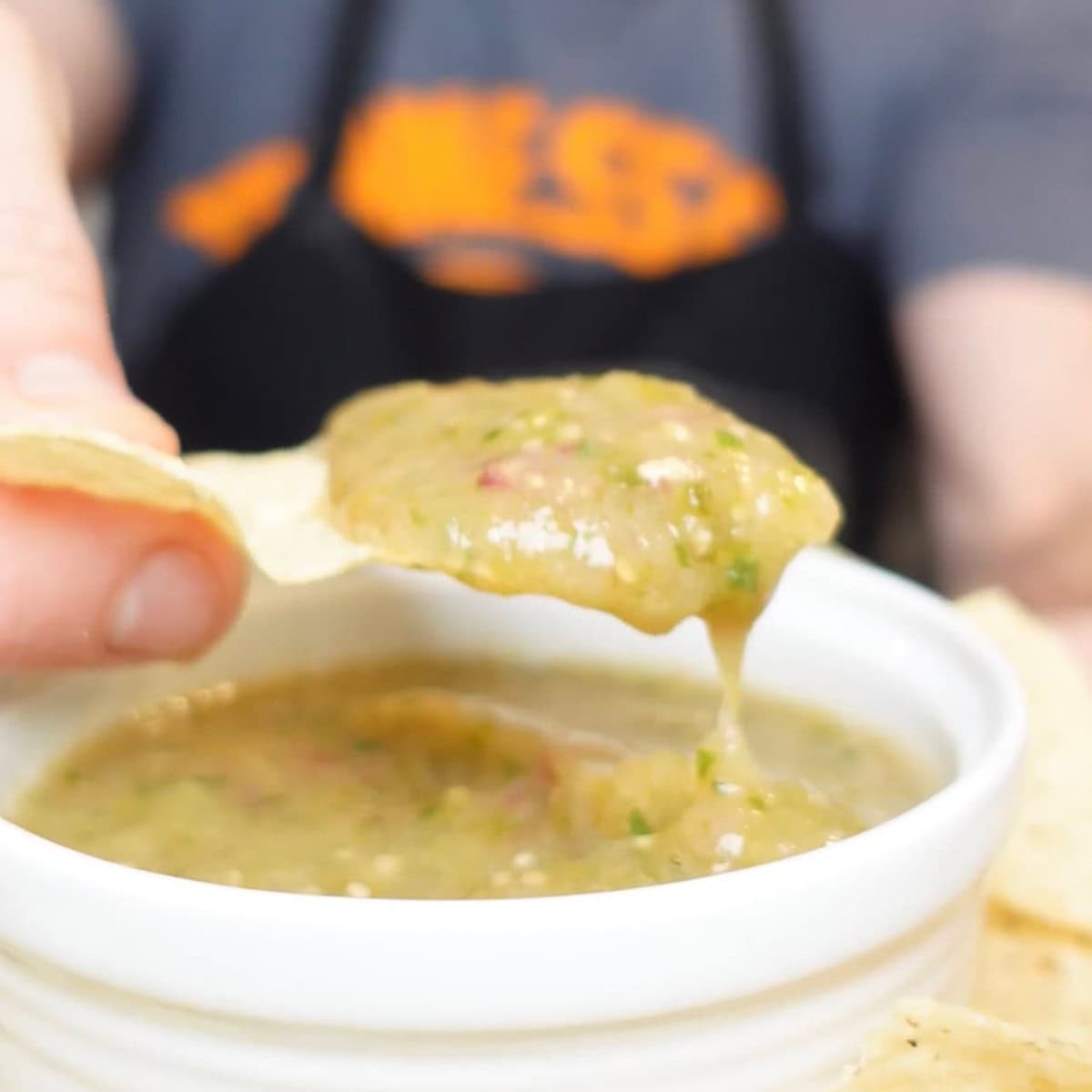 a scoop of verde salsa on a chip.