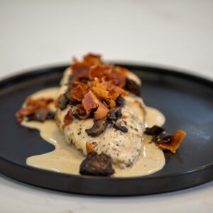Chicken topped with cream and bacon.