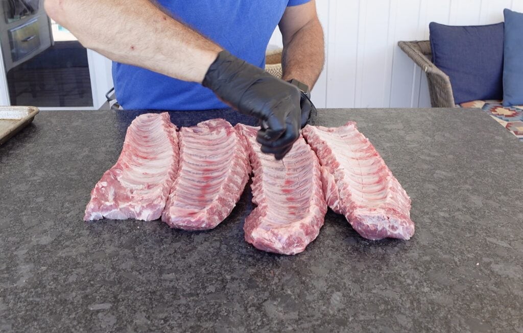 Removing the membrane from the pork ribs.