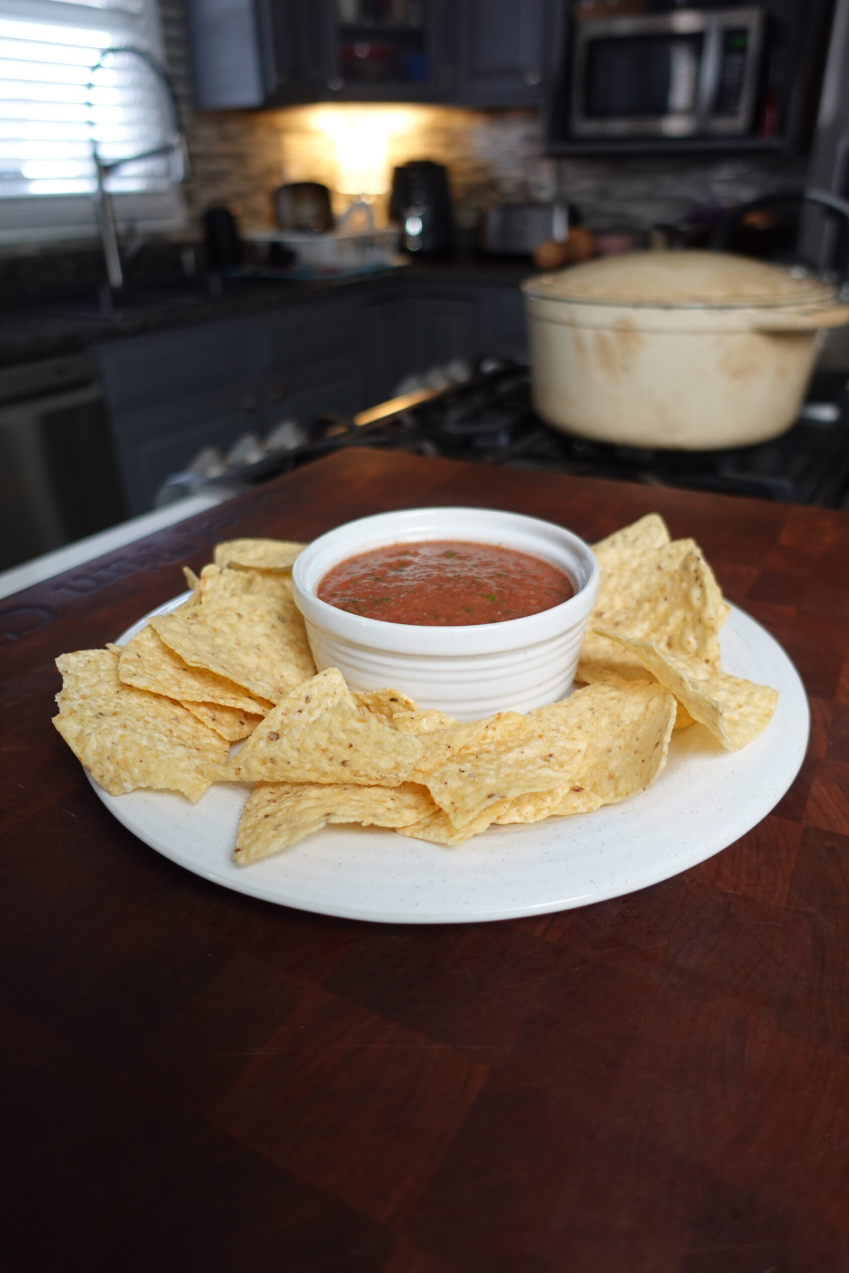 Salsa in a dish surrounded by chips.