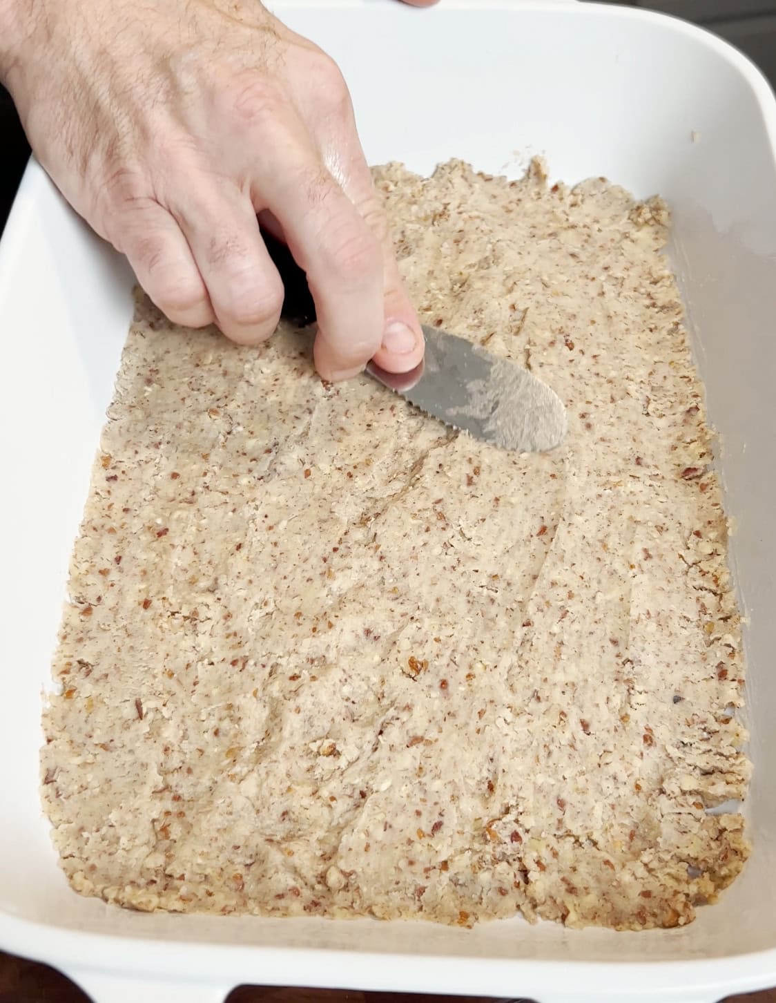 Pressing a crust into a baking dish.