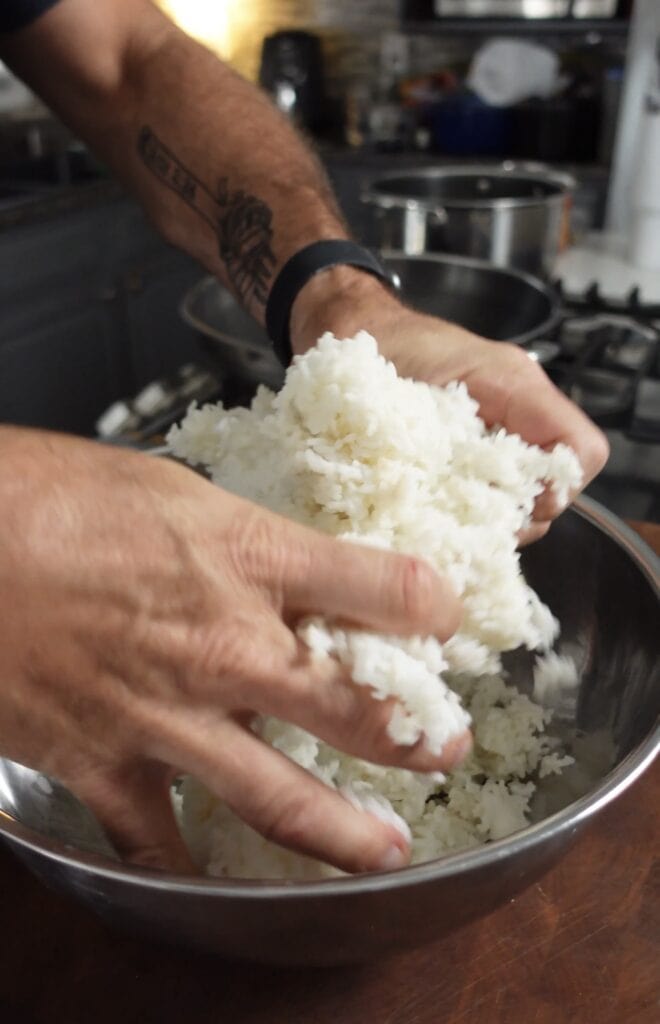Breaking apart rice in a bowl.
