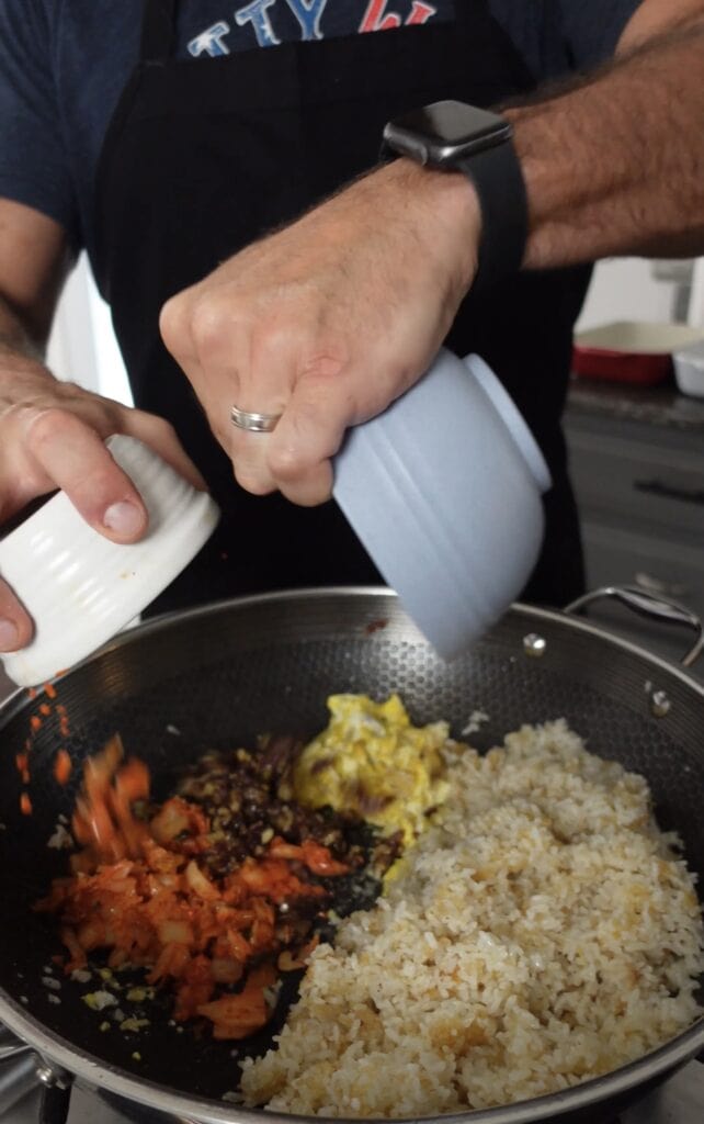 Kimchi and rice in a wok pan.