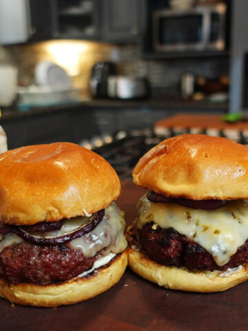 A hamburger with pepper jack cheese and grilled onions.