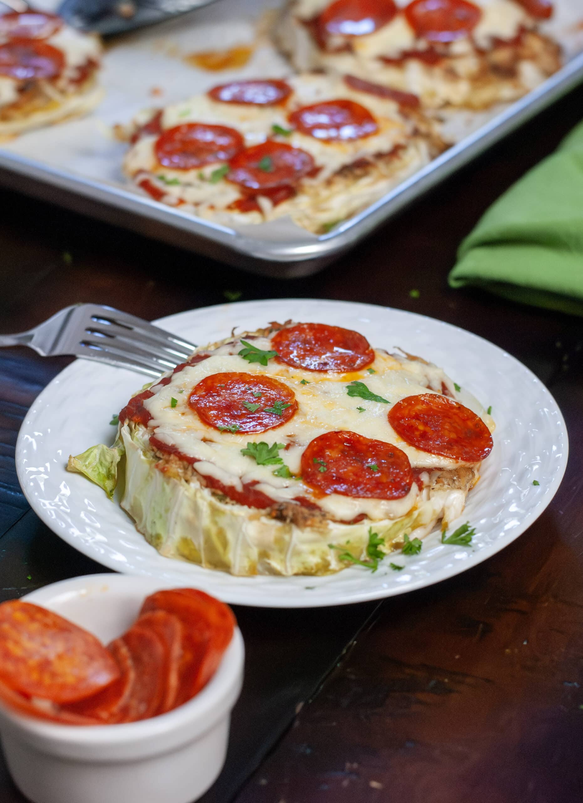 Cabbage pizza with pepperoni on a plate.