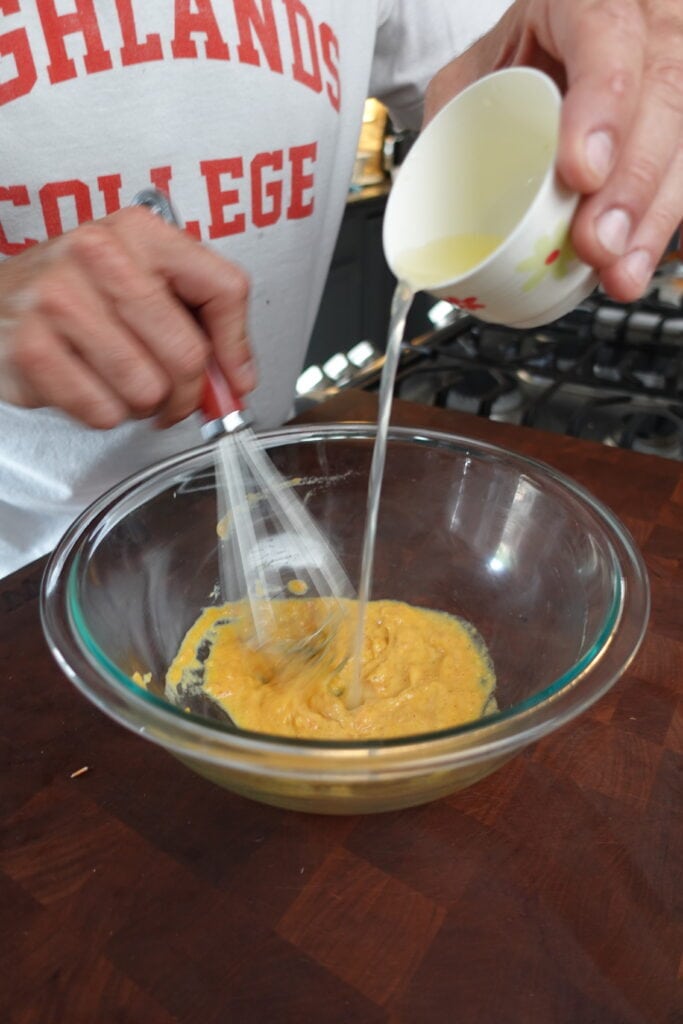 whisking homemade caesar dressing ingredients