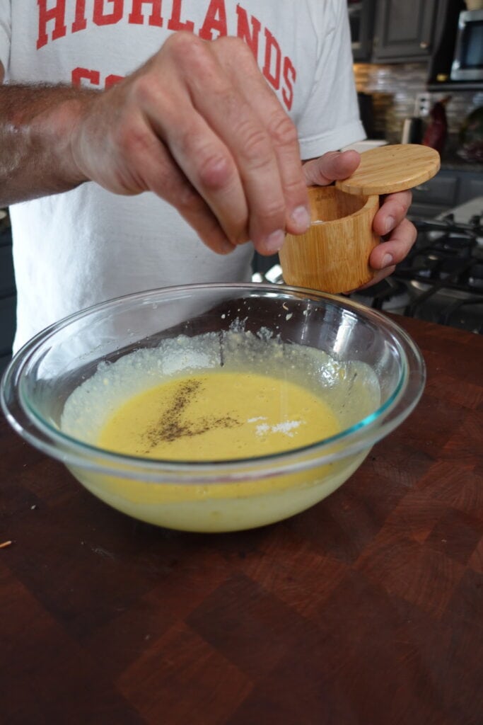 Salt going into a salad dressing.