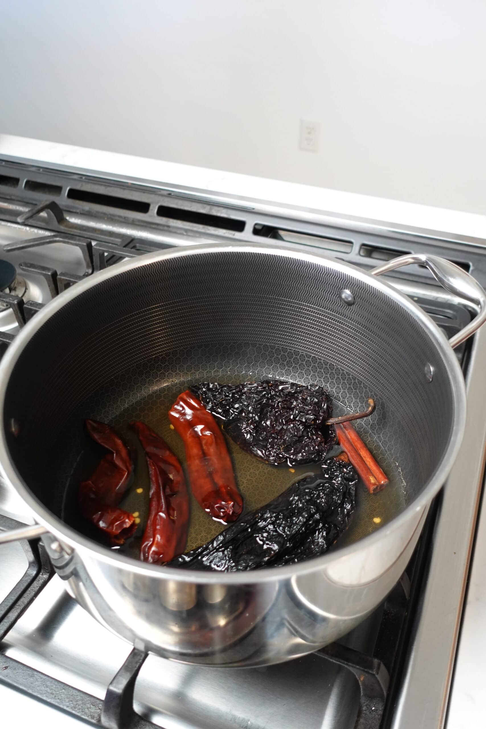 Peppers in a pot to make Birria Sauce.