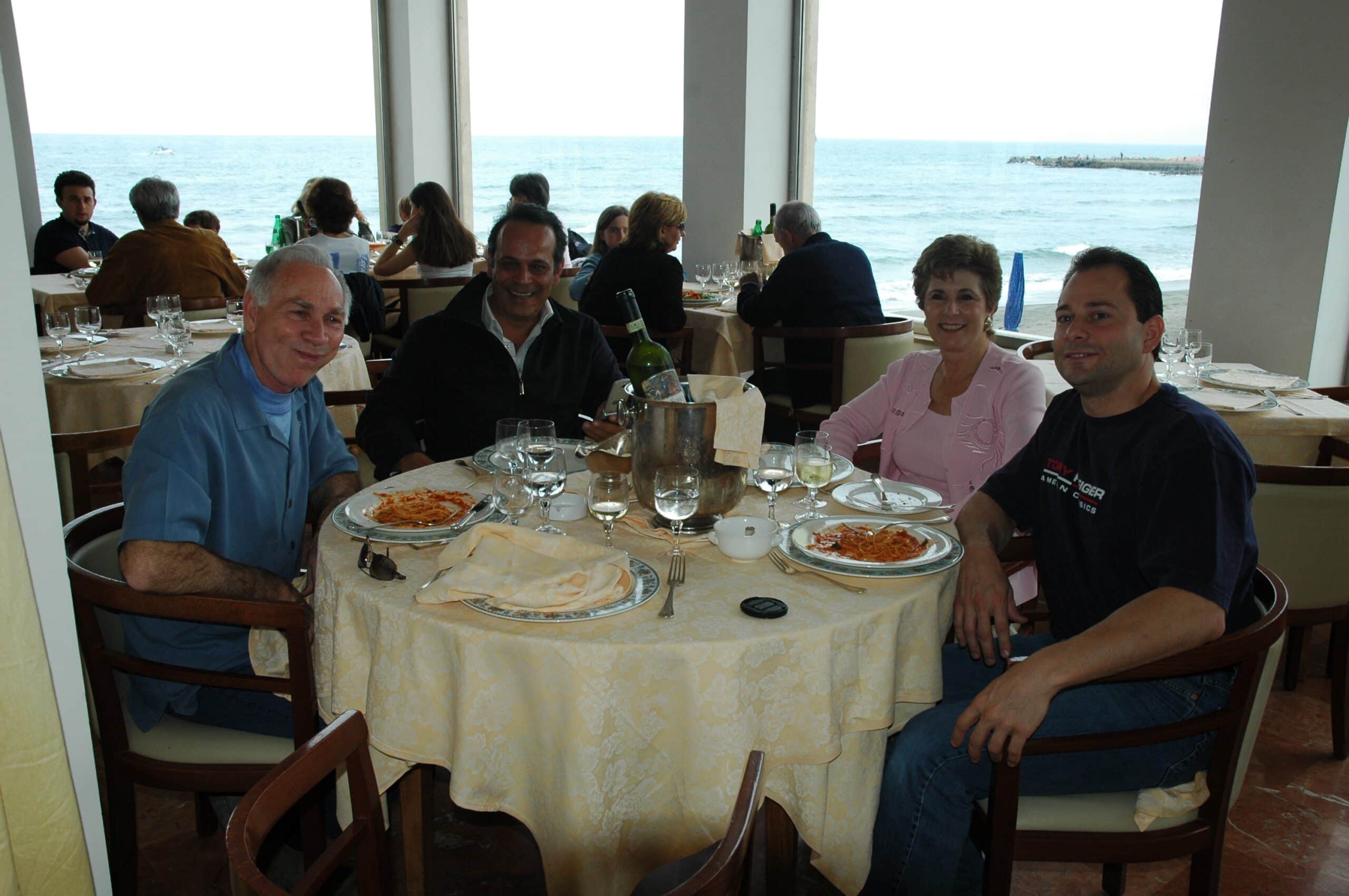 Tim with his mom, dad and brother eating Italian.