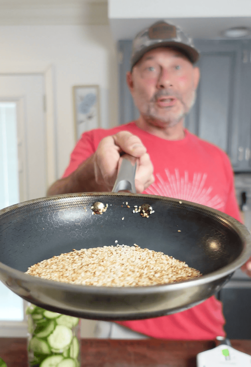 Toasted sesame seeds in a skillet.