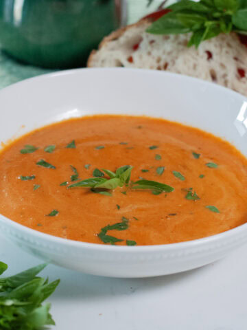 Tomato Basil Soup with basil leaves.