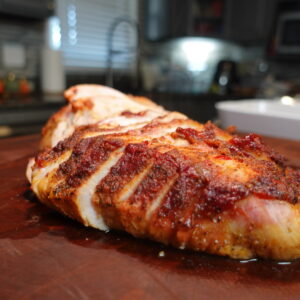 Creole Style Turkey breast slices on a cutting board.