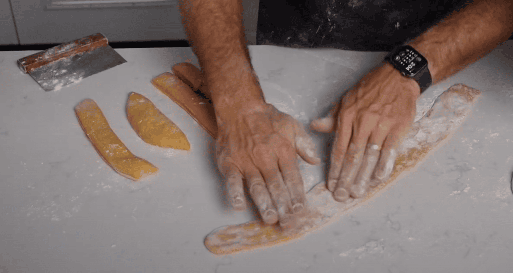 Rolling out pasta for ravioli.