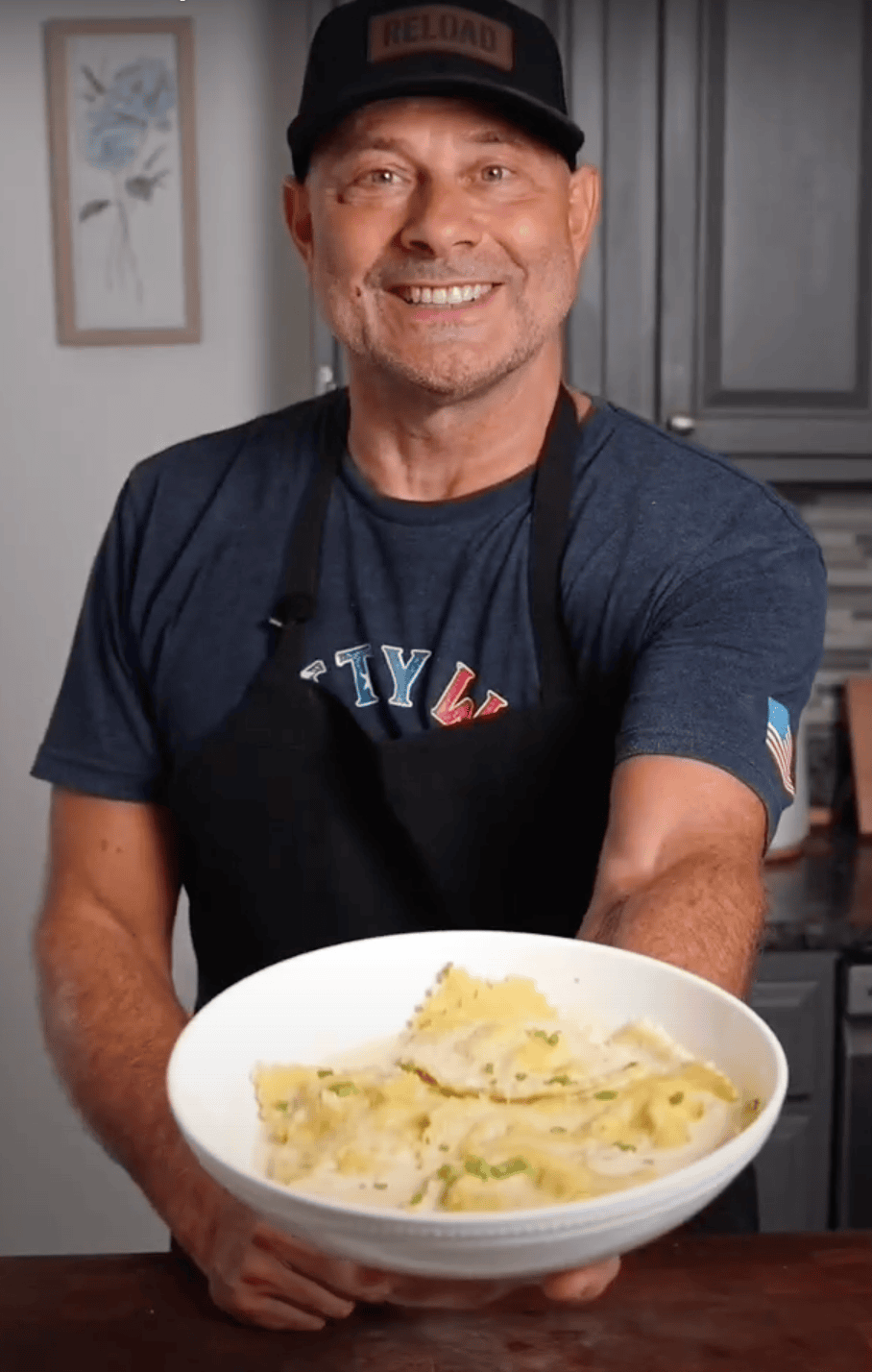 Tim holding a bowl of pumpkin ravioli.