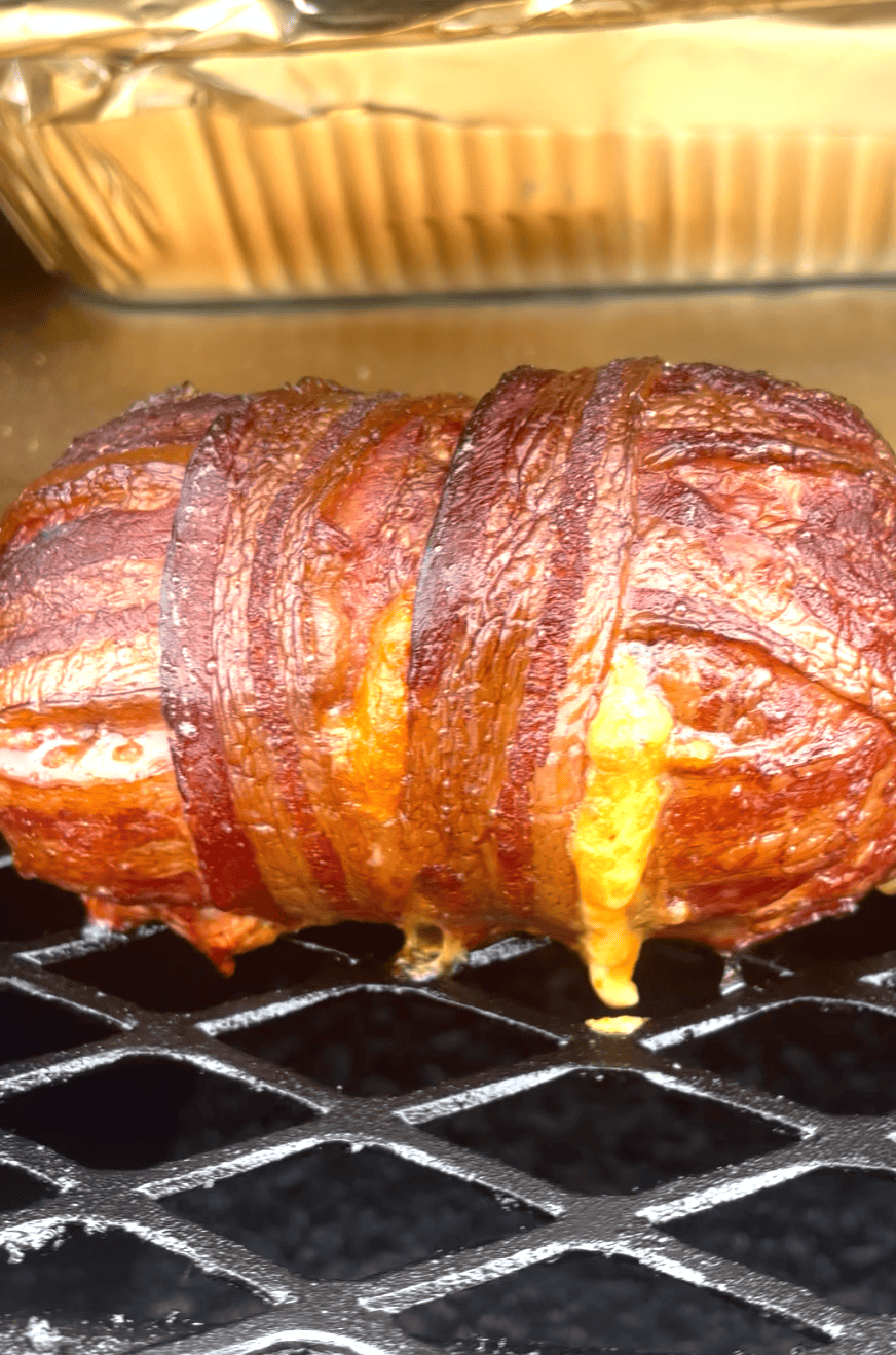Armadillo egg wrapped in bacon on the grill.